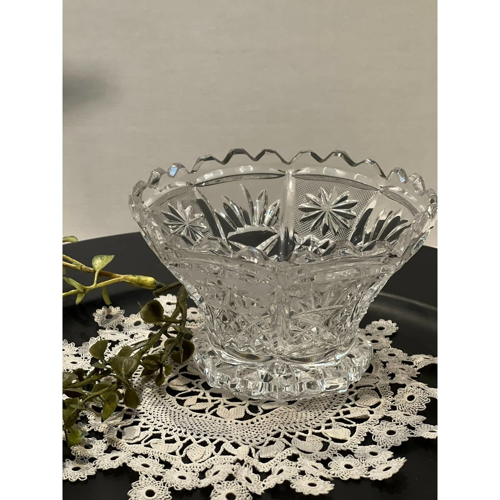 Crystal cut small bowl on single foot with saw tooth edge